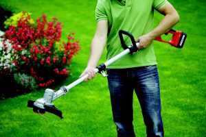 Man holding the best battery powered strimmer