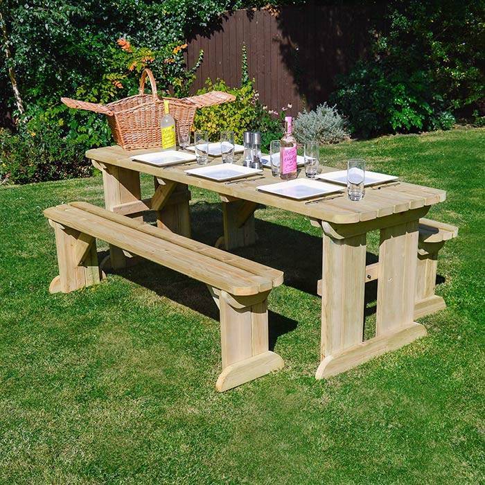 Tinwell Wooden Picnic Table and Bench Set in a garden with Green Grass and tablle Set