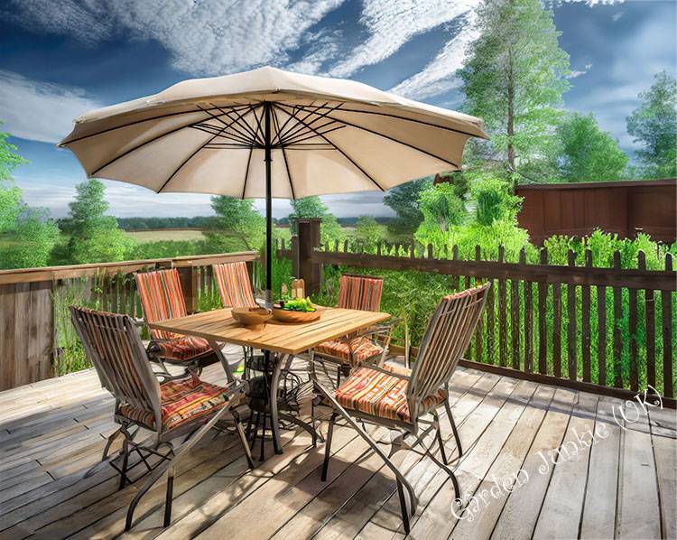 Garden Furniture - Table chairs and an umbrella on a patio with garden view